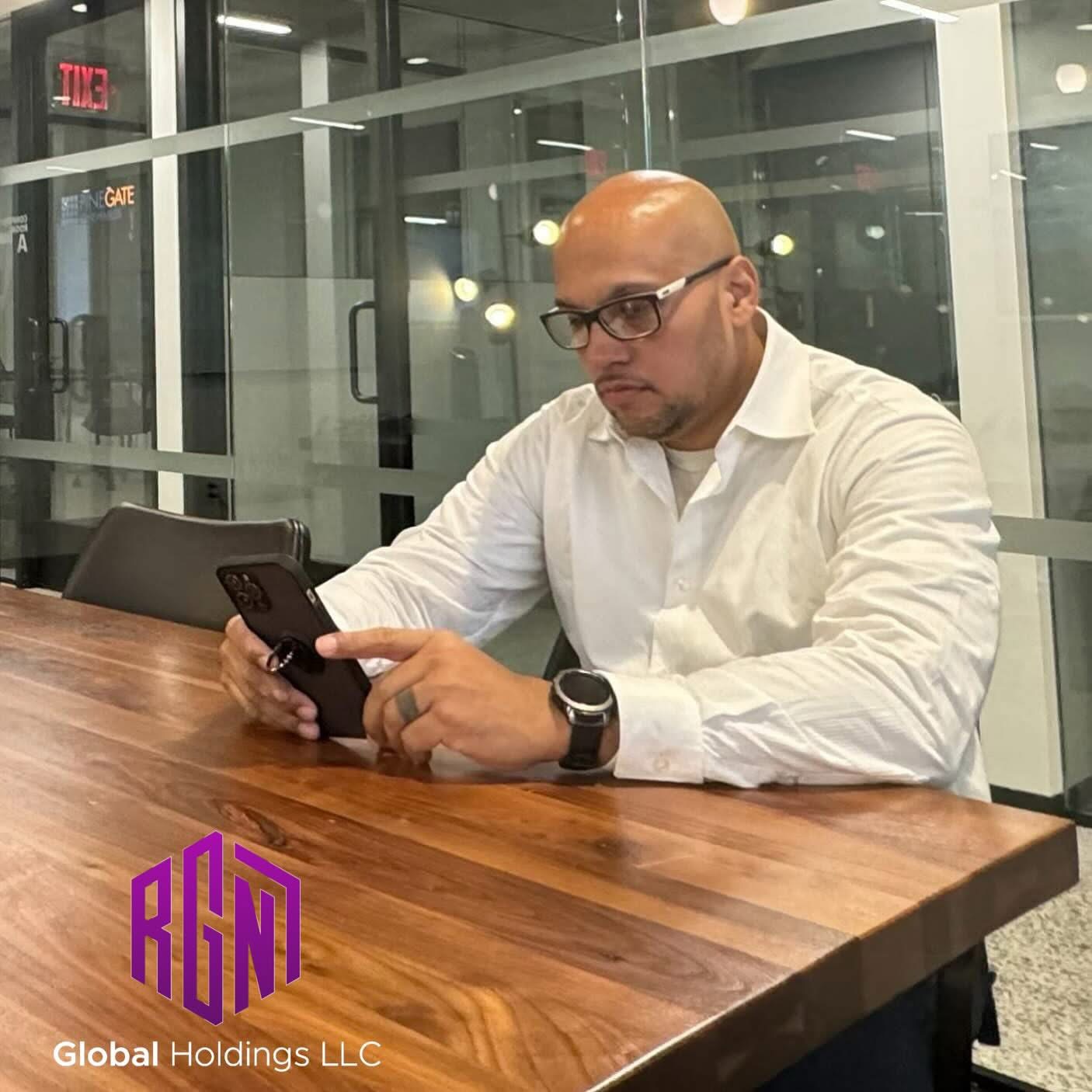 Felix Kon Alvarez working at the RGN 7 Global Holdings conference table